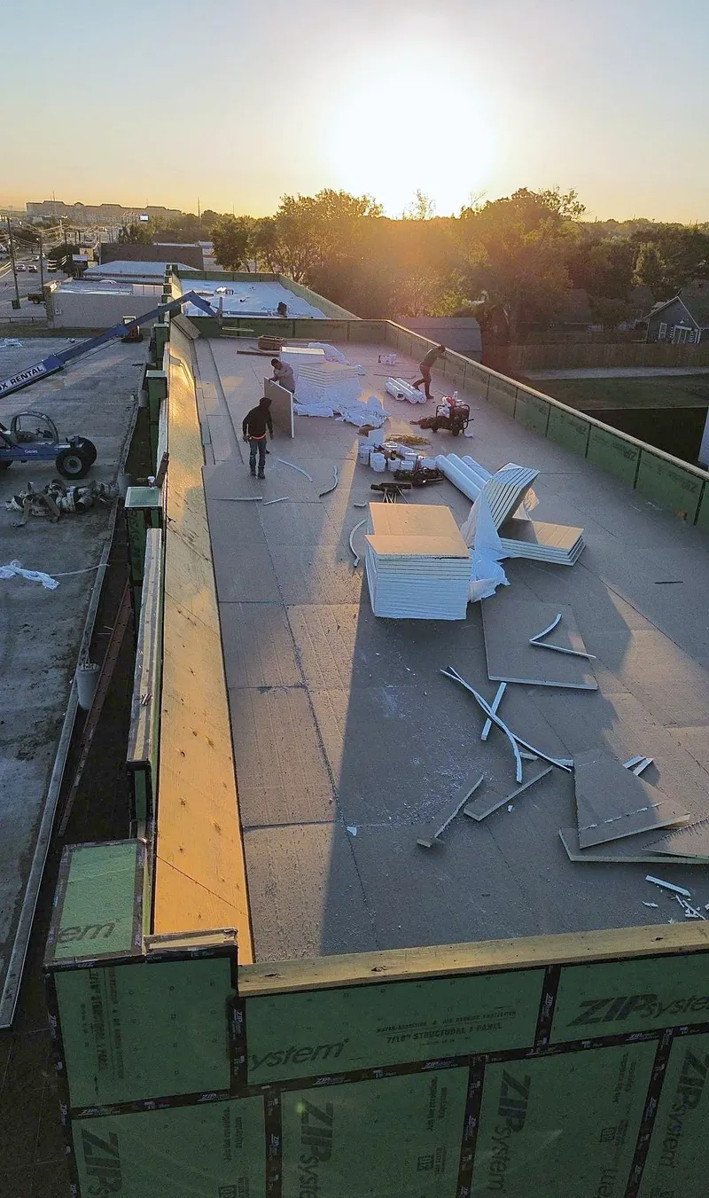 A crew working on a flat roof on a new building